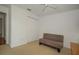 Light and airy bedroom with neutral walls and carpet features a couch and closet at 13511 Avista Dr, Tampa, FL 33624