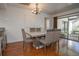 Charming dining area featuring a modern chandelier, hardwood floors, and seating for six at 13511 Avista Dr, Tampa, FL 33624
