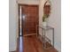Inviting foyer featuring hardwood floors, modern console table, and a decorative mirror at 13511 Avista Dr, Tampa, FL 33624