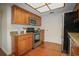 Modern kitchen featuring stainless steel appliances, hardwood floors, granite countertops, and light wood cabinets at 13511 Avista Dr, Tampa, FL 33624