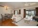 Open-concept living room and dining area with hardwood floors and sliding glass doors to the lanai at 13511 Avista Dr, Tampa, FL 33624