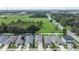 Aerial view showcasing a neighborhood with well-maintained homes, spacious yards, and nearby roads at 13822 Harvestwood Ln, Riverview, FL 33569