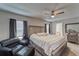 Neutral bedroom with a ceiling fan, large bed, and dark curtains for a relaxing atmosphere at 13822 Harvestwood Ln, Riverview, FL 33569