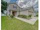 Charming two-story home featuring a well-maintained lawn and an attached two-car garage at 13822 Harvestwood Ln, Riverview, FL 33569