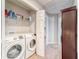 Convenient laundry room with a modern washer and dryer, overhead shelving for storage, and easy access at 13822 Harvestwood Ln, Riverview, FL 33569