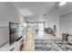 Open-concept living area featuring light wood floors and a comfortable seating area with a plush rug at 13822 Harvestwood Ln, Riverview, FL 33569