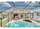 Screened-in patio area with a hot tub, outdoor seating, bar, and a game area for entertaining at 13822 Harvestwood Ln, Riverview, FL 33569