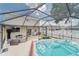 Enjoyable outdoor living space with a hot tub, grill, bar, game area, and comfortable seating at 13822 Harvestwood Ln, Riverview, FL 33569