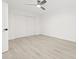 This bedroom features wood floors, a fan, and a sliding closet door at 13934 Clubhouse Cir # 8, Tampa, FL 33618