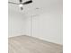 An all-white bedroom with a ceiling fan and a large closet at 13934 Clubhouse Cir # 8, Tampa, FL 33618