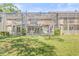 Townhome's backyard with a lush lawn and a fully screened outdoor living space at 13934 Clubhouse Cir # 8, Tampa, FL 33618