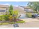 Two-car garage with driveway, attractive landscaping, and convenient mailbox enhance curb appeal at 13934 Clubhouse Cir # 8, Tampa, FL 33618