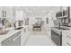 Open kitchen featuring white cabinets, stainless steel appliances, and seamless flow to living and dining areas at 13934 Clubhouse Cir # 8, Tampa, FL 33618