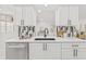 Close up of the kitchen featuring white cabinetry, a black faucet, and a stylish backsplash at 13934 Clubhouse Cir # 8, Tampa, FL 33618