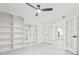 Spacious living room with built-in shelving, a ceiling fan, and seamless flow to other areas at 13934 Clubhouse Cir # 8, Tampa, FL 33618