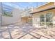 A covered patio featuring an outdoor ceiling fan, brick pavers, and a lush landscaped exterior at 13934 Clubhouse Cir # 8, Tampa, FL 33618