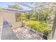 Spacious screened-in patio overlooking a grassy area and mature trees at 13934 Clubhouse Cir # 8, Tampa, FL 33618
