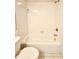Clean bathroom featuring a white tiled tub and toilet at 141 Lakeside Dr, Oldsmar, FL 34677