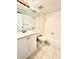 Bright bathroom featuring a bathtub, toilet, vanity, and neutral tile at 141 Lakeside Dr, Oldsmar, FL 34677
