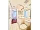Bathroom with neutral tile, vanity, toilet, and view to hallway at 141 Lakeside Dr, Oldsmar, FL 34677