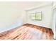 Bright bedroom with wood flooring, a window, and closet at 141 Lakeside Dr, Oldsmar, FL 34677