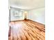A bright bedroom features wood-look floors, neutral walls, and a large window with natural light at 141 Lakeside Dr, Oldsmar, FL 34677