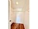 A walk-in closet is ready for storage with wood-look flooring and shelving for clothing and accessories at 141 Lakeside Dr, Oldsmar, FL 34677