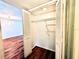 Open closet with wire shelving and bi-fold doors, with view to living space at 141 Lakeside Dr, Oldsmar, FL 34677