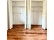 Spacious closet featuring wood flooring, white walls, bi-fold doors, and ample shelving for organized storage at 141 Lakeside Dr, Oldsmar, FL 34677