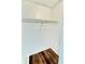 A small walk-in closet features wood-look floors and white walls with metal storage shelves at 141 Lakeside Dr, Oldsmar, FL 34677