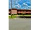 Exterior of building with covered parking, landscaping, and visible unit entrances under a cloudy sky at 141 Lakeside Dr, Oldsmar, FL 34677