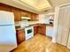 Functional kitchen with warm wood cabinets, modern appliances, and a pass-through to the dining area at 141 Lakeside Dr, Oldsmar, FL 34677