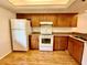 Well-lit kitchen featuring wooden cabinetry, modern appliances, and a smooth countertop, perfect for cooking at 141 Lakeside Dr, Oldsmar, FL 34677