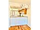 Bright, efficient kitchen featuring a pass-through, wooden cabinets, modern appliances, and modern lighting at 141 Lakeside Dr, Oldsmar, FL 34677