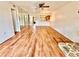 Bright living room features wood floors, ceiling fan, stone fireplace, and mirrored wall at 141 Lakeside Dr, Oldsmar, FL 34677