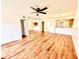 Bright living room features wood floors, ceiling fan, and mirrored wall at 141 Lakeside Dr, Oldsmar, FL 34677