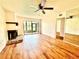 Bright living room features wood floors, fireplace, and screened patio at 141 Lakeside Dr, Oldsmar, FL 34677