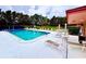 Community pool featuring a ladder, lounge chairs and seating areas, providing a refreshing and relaxing space at 141 Lakeside Dr, Oldsmar, FL 34677