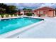 Community pool featuring a ladder, stairs, lounge chairs and seating areas, providing a refreshing and relaxing space at 141 Lakeside Dr, Oldsmar, FL 34677