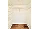 Spacious walk-in closet with wire shelving and wood-look flooring at 141 Lakeside Dr, Oldsmar, FL 34677