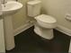 Bathroom featuring a pedestal sink, tile floor, and toilet at 15244 Anguilla Isle Ave, Tampa, FL 33647