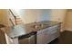Kitchen island with stainless sink, dishwasher and dark granite countertops at 15244 Anguilla Isle Ave, Tampa, FL 33647