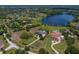 Expansive aerial view of a luxury community with lake access, manicured lawns, and estate homes at 17129 Breeders Cup Dr, Odessa, FL 33556