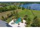 Aerial showcasing the backyard pool, expansive lawn, and lake frontage of this estate home at 17129 Breeders Cup Dr, Odessa, FL 33556
