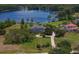 Breathtaking aerial view showcasing the luxurious home, sprawling lawn, and serene lake at 17129 Breeders Cup Dr, Odessa, FL 33556