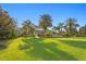Expansive green backyard with a stunning luxury home and pool area with gorgeous landscaping at 17129 Breeders Cup Dr, Odessa, FL 33556
