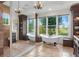 Luxurious bathroom with soaking tub, travertine floors, and views of the backyard at 17129 Breeders Cup Dr, Odessa, FL 33556