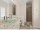 Clean bathroom showcasing a glass bowl sink, marble countertop, tile floor, and walk-in shower at 17129 Breeders Cup Dr, Odessa, FL 33556