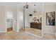 Elegant bathroom with chandeliers, double vanity, and stone floors at 17129 Breeders Cup Dr, Odessa, FL 33556