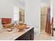 Bathroom featuring dark cabinets, a vessel sink, marble counters, and a tiled shower behind a glass door at 17129 Breeders Cup Dr, Odessa, FL 33556